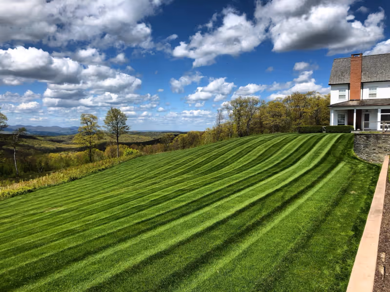 Estate maintenance service area with crisp lawn, beds, and property presentation.