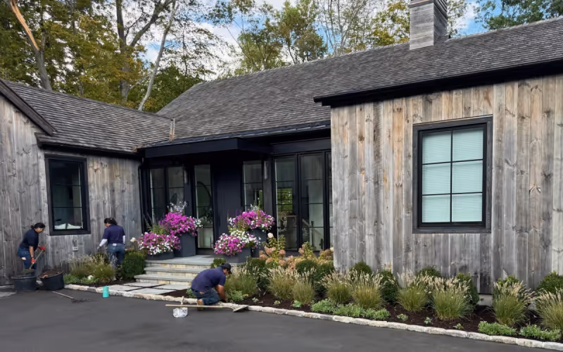 Finished planting bed and seasonal entry plantings at a residential property.