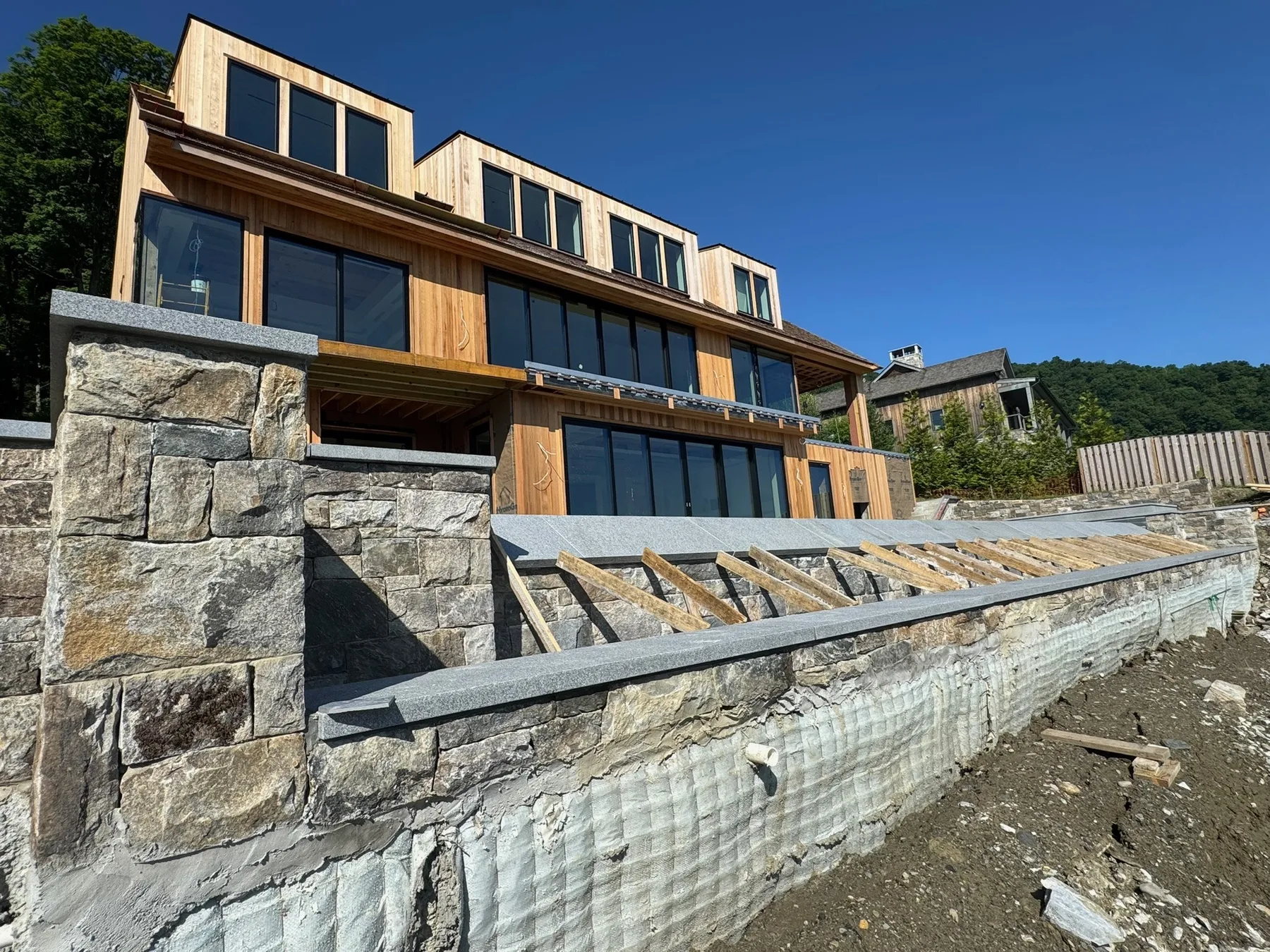 Custom poolside stonework and wall detailing at a high-end residential outdoor living space.